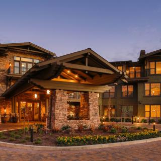 A beautifully lit house with charming architecture in the evening.