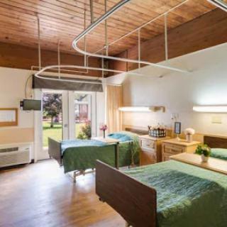 A spacious and well-lit hospital room designed for patient comfort.