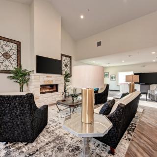 A modern living room with a cozy fireplace, elegant furniture, and stylish decor.