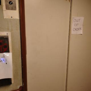 A door with a sign indicating that it is out of order.