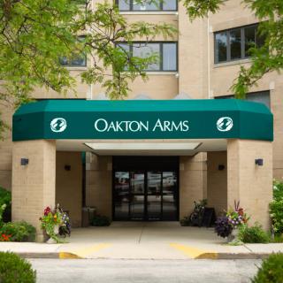 Entrance of a building with 'Oakton Arms' written on the green awning.