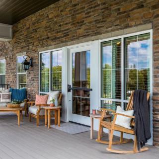 Cozy outdoor patio with rocking chairs and stylish decor.