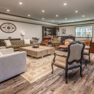 A cozy living room featuring elegant seating, a central coffee table, and warm lighting.