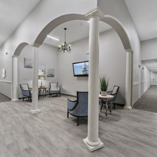 A modern lobby interior with elegant columns and a cozy seating area.