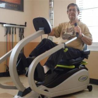 A person using an exercise machine in a gym setting.