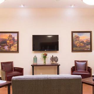 A cozy living room with modern furniture and decorative artwork.