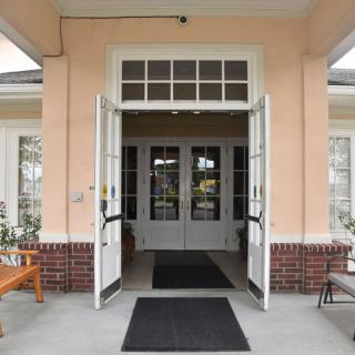 An inviting entrance with open double doors leading into a building.