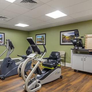 A small gym room featuring stationary bikes and fitness equipment.