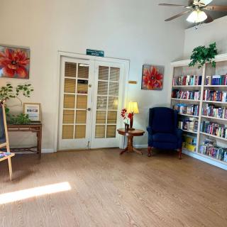 A cozy living room with a bookshelf and armchair.