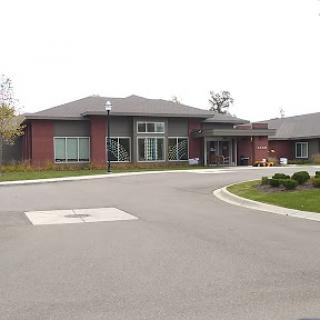 A well-designed contemporary building with a welcoming entrance, surrounded by landscaped greenery.