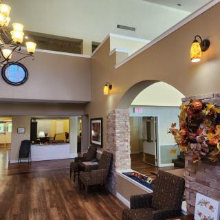 A spacious lobby area featuring seating, warm lighting, and seasonal decorations.