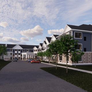 A modern residential building featuring multiple units and landscaped surroundings.