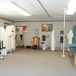 A clean and organized gym with various fitness machines and equipment.