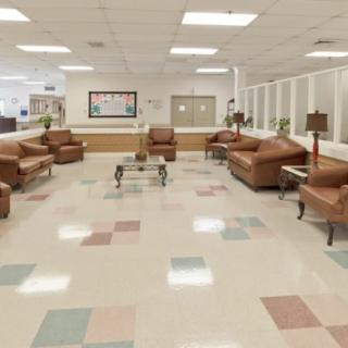 A spacious waiting room with comfortable seating and coffee tables.