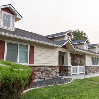 A modern single-story house with stone and siding exterior.