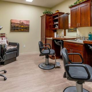A cozy and well-organized beauty salon interior with chairs and wooden cabinets.
