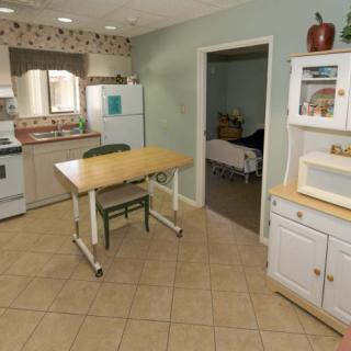 A cozy kitchen with a dining table and various appliances.