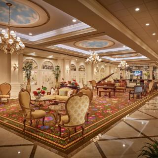 A luxurious lounge featuring opulent decor and a grand piano.