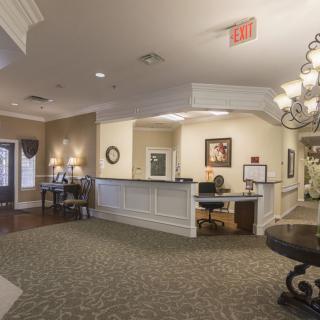 A well-decorated lobby with a reception desk and seating area.