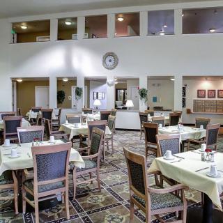 Spacious dining area with neatly arranged tables and chairs.
