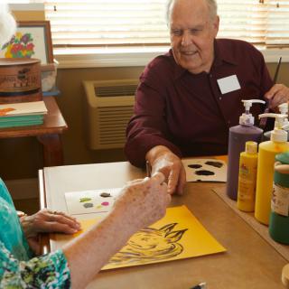 Seniors enjoying a painting session at a community center.
