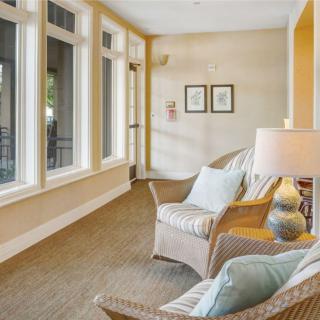 A cozy seating area with armchairs and large windows allowing natural light to fill the space.