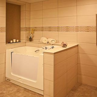 A modern bathroom featuring a walk-in bathtub and a stylish tile design.
