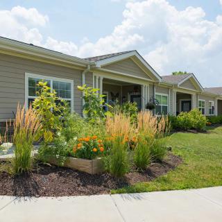 A suburban home with a well-maintained garden and landscaped front yard.