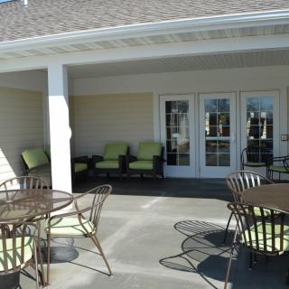 A patio area with comfortable outdoor seating and tables.