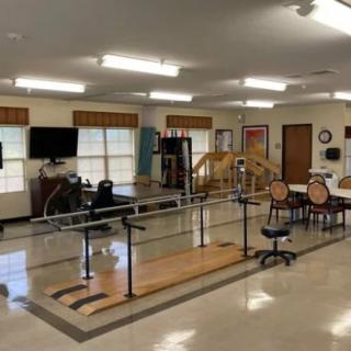 A well-equipped physical therapy center with exercise equipment and treatment areas.