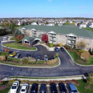 Aerial view of a suburban apartment complex with a parking lot.