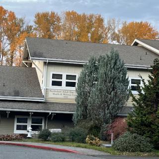 A cozy building surrounded by autumn-colored trees, showcasing a serene atmosphere.