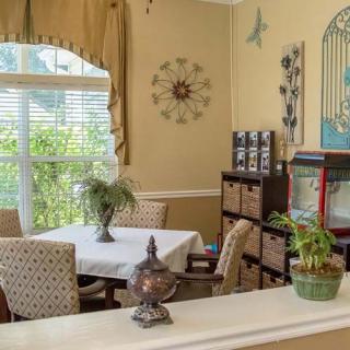 A cozy dining area with a table, chairs, and natural light streaming through the window.