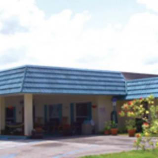 A suburban residential house with a driveway and garden.
