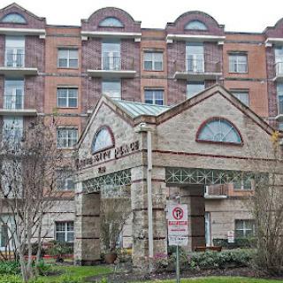A view of a multi-story residential building with a welcoming entrance.