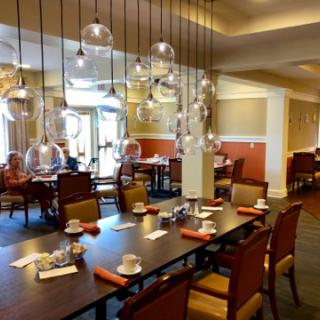A cozy and modern dining area featuring elegant lighting and a well-set table.