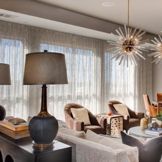 A modern living room with elegant lighting and cozy seating arrangements.