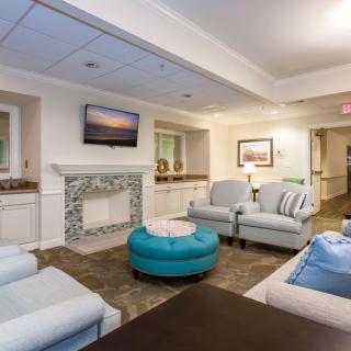 A cozy and modern living room with comfortable seating, a fireplace, and a television.