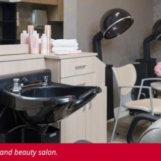 Interior of a modern beauty and hair salon with equipment and chairs.