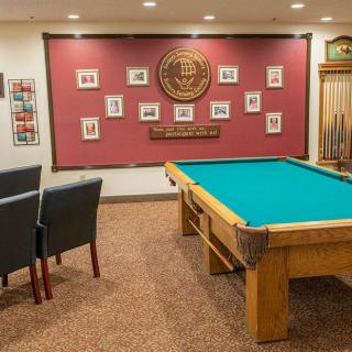 A cozy billiards room featuring a pool table and framed wall art.