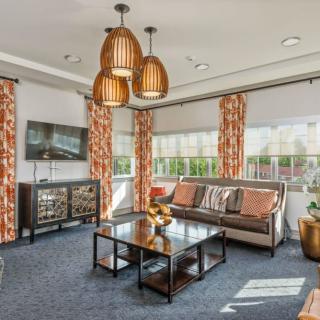 A modern living room featuring elegant furniture and warm lighting.