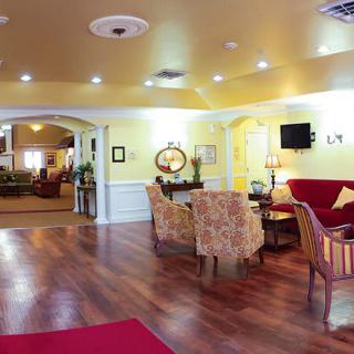 A cozy lobby with elegant furniture and warm lighting.