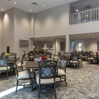 Spacious dining area with multiple tables and chairs set up for guests.