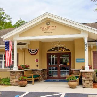 Entrance of a building with decorative flags and seating area.