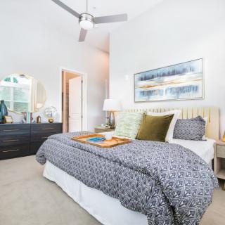 A well-lit modern bedroom with contemporary decor and stylish furnishings.