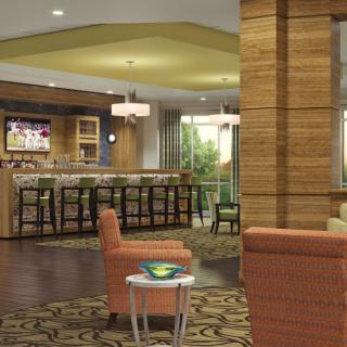 A modern bar and lounge with a cozy seating area.
