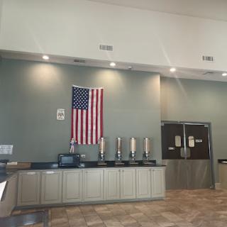Interior view showcasing an American flag and a service counter.