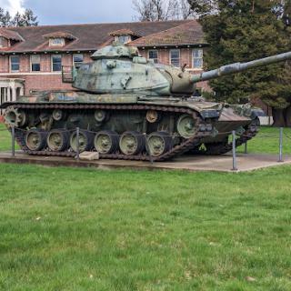 A historical military tank displayed on a grassy field.