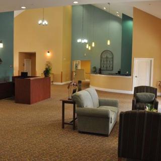 A modern hotel lobby with comfortable seating and a reception desk.