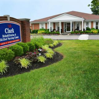 A well-maintained rehabilitation and nursing center with a landscaped garden and clear signage.